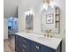 Double vanity with navy blue cabinets, white countertop, and modern gold fixtures at 107 Long Shadow Ln, Cary, NC 27518