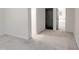 Bedroom with door and view into the bathroom, neutral walls and carpet at 107 Long Shadow Ln, Cary, NC 27518