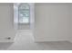 Sunlit bedroom with vaulted ceilings, a charming arched window, and neutral carpet at 107 Long Shadow Ln, Cary, NC 27518