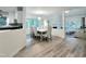 Dining room with a modern chandelier and adjacent kitchen space at 107 Long Shadow Ln, Cary, NC 27518