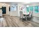 Dining area showcasing stylish seating, lighting, and views into the living room and kitchen at 107 Long Shadow Ln, Cary, NC 27518