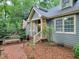 Exterior of home shows front entry, brick path, mature shrubbery, and a quaint bench at 107 Long Shadow Ln, Cary, NC 27518