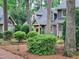 Attractive home exterior showcasing multiple units, mature trees, and manicured landscaping, offering a serene setting at 107 Long Shadow Ln, Cary, NC 27518