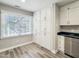Compact kitchen area featuring all white cabinetry, a stainless dishwasher, and bright natural light at 107 Long Shadow Ln, Cary, NC 27518