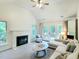 Living room with white fireplace, vaulted ceiling, and access to the outdoor deck at 107 Long Shadow Ln, Cary, NC 27518