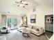Bright living room with vaulted ceilings, comfortable seating, and access to the outdoor deck at 107 Long Shadow Ln, Cary, NC 27518
