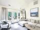 Bright living room with a white sectional sofa and French doors to the outdoor deck at 107 Long Shadow Ln, Cary, NC 27518