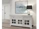 Elegant living space showcasing a decorative cabinet, artwork, and ample natural light, perfect for relaxation and entertainment at 107 Long Shadow Ln, Cary, NC 27518