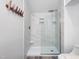 Stylish shower features marble-look tile, glass enclosure, and built-in niche at 107 Long Shadow Ln, Cary, NC 27518