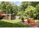 Landscaped backyard featuring a pool and a cozy seating area, ideal for outdoor enjoyment and relaxation at 108 Hanover Pl, Chapel Hill, NC 27516