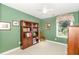 Green bedroom with a bookcase and a window with a view of the outdoors at 108 Hanover Pl, Chapel Hill, NC 27516