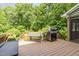 Outdoor deck with grill and green surroundings offer a perfect spot for relaxation and entertainment at 108 Hanover Pl, Chapel Hill, NC 27516