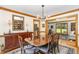 Elegant dining room featuring a large wood table, chandelier, and a view into the adjacent living room at 108 Hanover Pl, Chapel Hill, NC 27516