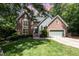Charming two-story home with a brick facade, attached garage, manicured lawn and mature trees at 108 Hanover Pl, Chapel Hill, NC 27516