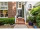 Elegant entryway featuring a black front door with decorative glass and brick steps at 108 Hanover Pl, Chapel Hill, NC 27516