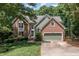 Inviting two-story home with a brick facade, green siding, and a well-kept lawn enhancing its curb appeal at 108 Hanover Pl, Chapel Hill, NC 27516