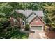Charming two-story home with a well-manicured lawn, brick accents, and an attached two-car garage at 108 Hanover Pl, Chapel Hill, NC 27516