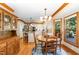 Bright kitchen with island, stainless appliances, breakfast nook, wood floors, and large window at 108 Hanover Pl, Chapel Hill, NC 27516