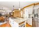 Open kitchen featuring a granite island with seating, white cabinets, and hardwood floors at 108 Hanover Pl, Chapel Hill, NC 27516