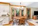 Cozy kitchen nook with wooden table, chairs, and natural light from bay windows at 108 Hanover Pl, Chapel Hill, NC 27516