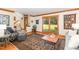 Cozy living room with hardwood floors, neutral walls, a patterned rug, and a view of the front entrance at 108 Hanover Pl, Chapel Hill, NC 27516
