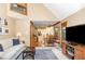 Open floor plan with kitchen view, wood floors, and natural light from large windows at 108 Hanover Pl, Chapel Hill, NC 27516