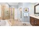 Bright bathroom showcasing a tiled glass shower, soaking tub, and double door access at 108 Hanover Pl, Chapel Hill, NC 27516