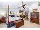Spacious main bedroom featuring a fireplace, ceiling fan, and a four-poster bed at 108 Hanover Pl, Chapel Hill, NC 27516