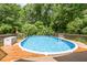 Outdoor pool provides a refreshing escape surrounded by a wooden deck, perfect for summer fun at 108 Hanover Pl, Chapel Hill, NC 27516
