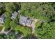 An aerial view of a home nestled amongst the trees and an ample driveway at 108 Hotelling Ct, Chapel Hill, NC 27514