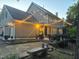 Home's backyard patio features decorative lighting, garden beds, and stone benches at 108 Hotelling Ct, Chapel Hill, NC 27514
