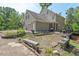Backyard with patio, stone benches, garden beds and mature landscaping at 108 Hotelling Ct, Chapel Hill, NC 27514