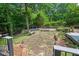 The backyard is designed for entertaining, featuring a stone patio and mature landscaping at 108 Hotelling Ct, Chapel Hill, NC 27514