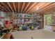 A spacious unfinished basement provides ample storage space with shelving and easy outdoor access at 108 Hotelling Ct, Chapel Hill, NC 27514