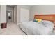Bright bedroom with a wooden headboard, cozy carpet, and double door closet at 108 Hotelling Ct, Chapel Hill, NC 27514