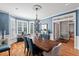 Elegant dining room features hardwood floors, blue walls, and large windows at 108 Hotelling Ct, Chapel Hill, NC 27514