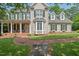 Charming home with manicured lawn, brick walkway, covered porch, and green shutters at 108 Hotelling Ct, Chapel Hill, NC 27514