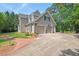 Charming home with a well-manicured lawn, brick walkway, and three-car garage at 108 Hotelling Ct, Chapel Hill, NC 27514