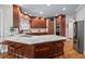Modern kitchen island with marble countertop, wooden cabinetry, and stainless steel appliances at 108 Hotelling Ct, Chapel Hill, NC 27514