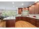 Spacious kitchen with marble countertops, wood cabinetry, and a breakfast bar, perfect for casual dining and entertaining at 108 Hotelling Ct, Chapel Hill, NC 27514