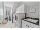 Convenient laundry room with modern appliances, a sink, and overhead storage at 108 Hotelling Ct, Chapel Hill, NC 27514