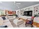 Inviting living room with plush sectional sofa, custom built-ins, and view into adjacent kitchen area at 108 Hotelling Ct, Chapel Hill, NC 27514
