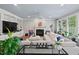 Sun-lit living room with fireplace, and cozy sectional sofa at 108 Hotelling Ct, Chapel Hill, NC 27514