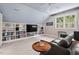 Upstairs living room with a large sofa, built-in shelving, and a ceiling fan at 108 Hotelling Ct, Chapel Hill, NC 27514