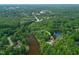 Overhead shot displaying the Lochmere Golf Club and Clubhouse, shopping, food, trees, and a pond on a clear day at 110 Glenrose Ln, Cary, NC 27518