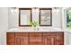 Bathroom featuring dual vanities with granite countertops, wood cabinets, and framed mirrors for a luxurious feel at 110 Glenrose Ln, Cary, NC 27518