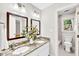 Bathroom featuring dual vanities with granite countertops, wood cabinets, framed mirrors and tiled shower at 110 Glenrose Ln, Cary, NC 27518