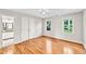Empty bedroom offers hardwood floors, closet and outdoor views through two windows at 110 Glenrose Ln, Cary, NC 27518