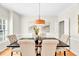 Formal dining room features a modern chandelier, neutral paint, and hardwood flooring at 110 Glenrose Ln, Cary, NC 27518