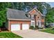 Charming two-story brick home with a two-car garage, black shutters, and well-maintained landscaping at 110 Glenrose Ln, Cary, NC 27518